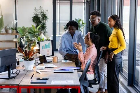 In office, team discussing data on computer screen, collaborating Fotos de archivo