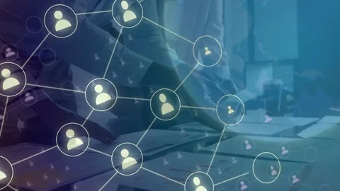 Office team leaning over table, faint graphic appearing then expanding into user Stock Footage 335732103