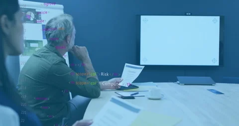 In office, team reviewing documents with animation of code overlay on screen Video stock 304763126
