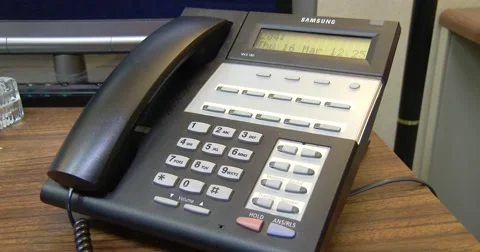 Office Telephone rings - "wrong number" Gets upset - hangs up - 4k Stock Footage 61301619