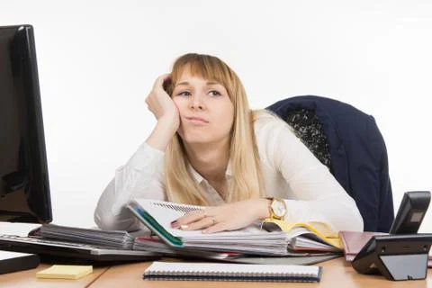 Office tired a specialist to work with documents and wants to go home Fotos Stock