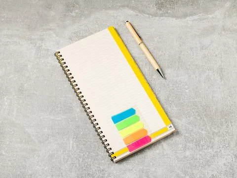 Office tools. Notepad and pen on gray office table Stock Photos