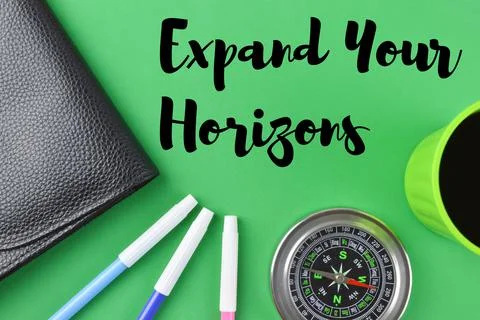 Office tools over green background written with EXPAND YOUR HORIZONS Foto stock