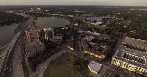 Office tower and rail line between lakes and apartments Stockbeeldmateriaal 64822751