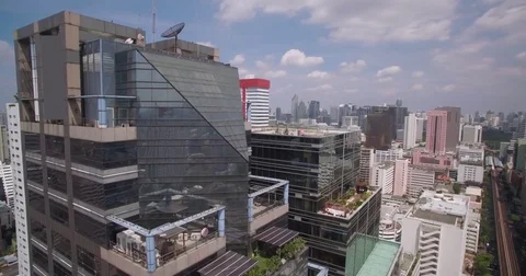 Office Tower In Silom District Of Central Bangkok, Thailand, Wraparound Aerial Stock Footage 80243183