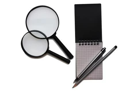 Office on a white background. Notepad, pen and magnifiert. Business and finan Stock Photos