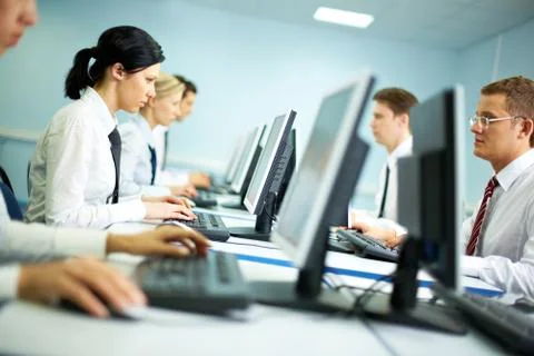 Office with white collar workers working on computers Stock Photos