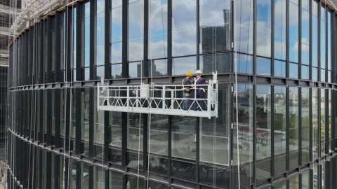 Office window installation worker in the construction site. House development Stock-Footage 143693390