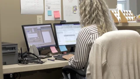 Office woman looking at a computer Stock Footage 188351594