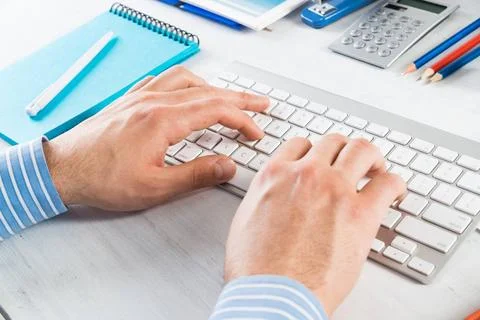 Office work at the computer close-up men s hands type on the keyboard. off... Stock-Fotos