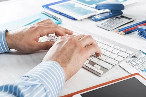 Office work at the computer close-up men s hands type on the keyboard. off... Stock-Fotos