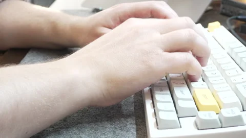 Office work at a computer, programmer typing quickly on a white keyboard, touch Stock Footage 328494416