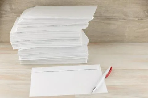 Office work with correspondence: a Stack of blank envelopes on a wooden table 写真素材