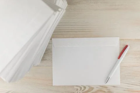 Office work with correspondence: a Stack of blank envelopes on a wooden table 写真素材