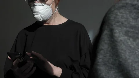Office work during a pandemic COVID-19. Young business woman and an elderly Stock Footage 128243151
