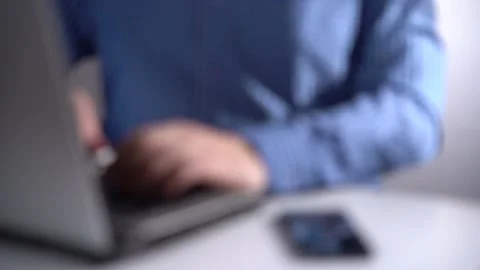 Office work. A man working on a laptop, next to a smartphone. Stock Footage 151857572