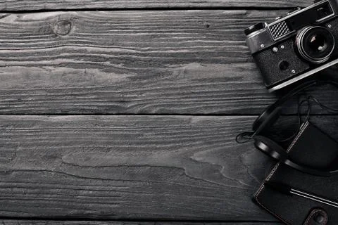 Office work space with camera, notebook, eyepieces, and pen. On a wooden surf Stock Photos