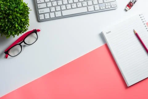 Office work space with computer keyboard, flash drive, notebook, pencil glass Stock Photos