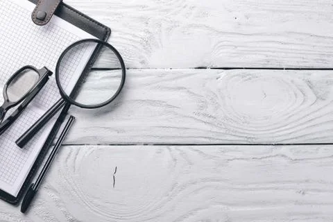Office work space, notebook, laptop and glasses. On a wooden surface. Top vie Stock Photos