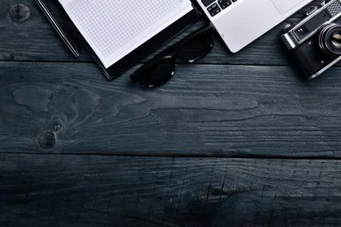 Office work space, notebook, laptop and glasses. On a wooden surface. Top vie Stock Photos
