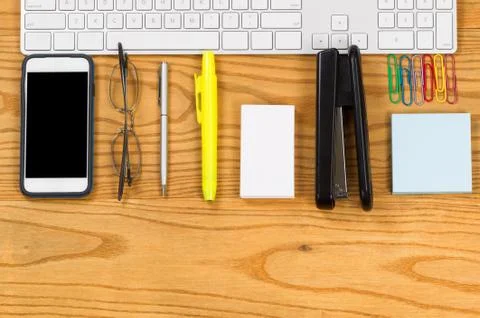 Office work supplies align with computer keyboard on desktop Stock Photos