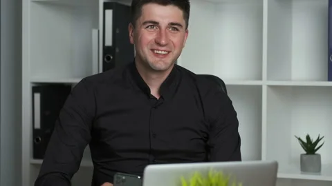 Office worker 30-year-old accountant writes in a notebook and talks on the phone Stock Footage 138583800