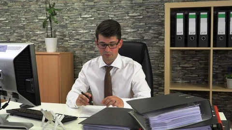 Office worker advises client and looks through documents Stock Footage 116313962