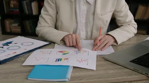 Office worker analyzes document with graphs and diagrams Stock Footage 300449610