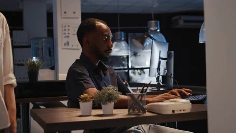 Office worker analyzing startup data on laptop to create project Stock Footage 213703261