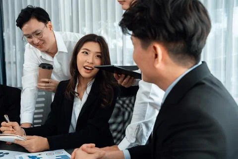 Office worker and manager analyze financial report paper in harmony workplace. Stock Photos