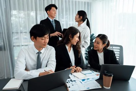 Office worker and manager analyze financial report paper in harmony workplace. Stock Photos