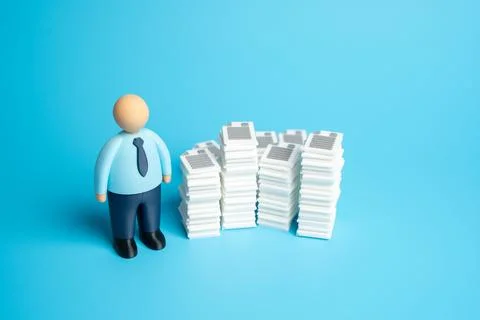 An office worker and stacks of documents and work papers. High bureaucratic b Stockfoto's
