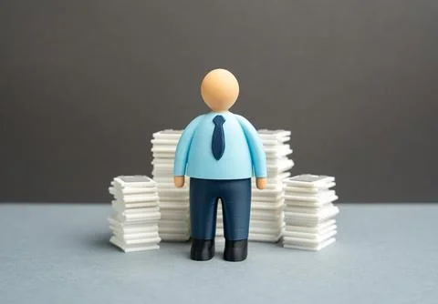 An office worker and stacks of papers and documents. Paperwork and reportin.. Stock Photos