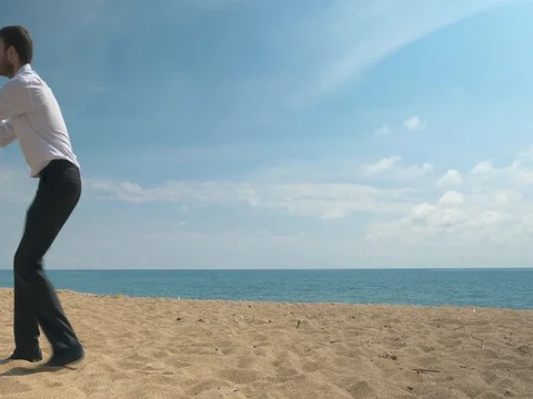 Office worker on the beach tries to sign business papers Stock Footage 76442824
