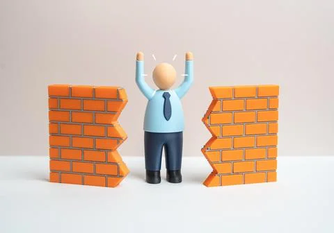 An office worker breaks down a wall to achieve a breakthrough. Innovation a.. 写真素材