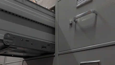 Office Worker Closing a File Cabinet in a File Storage Room. Stock Footage 106177230