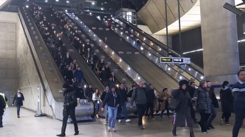 Office worker commuters during rush hour going up and down escalators at London Stock Footage 102945194