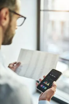 Office worker comparing the information from different sources Foto stock