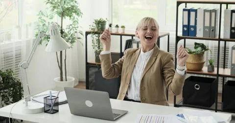 Office Worker Dances and Works Sitting at Desk in the Office Stock Footage 248533110