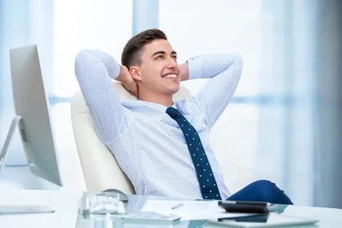 Office worker daydreaming at desk. Stock Photos