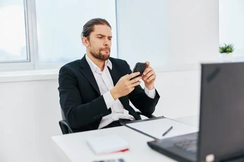 Office worker at the desk documents communication by phone technology Stock Photos