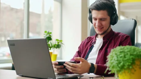 Office worker distracted from work using smartphone to check social network Video stock 220072967