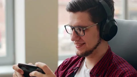 Office worker distracted from work using smartphone to check social network Stock Footage 220725906