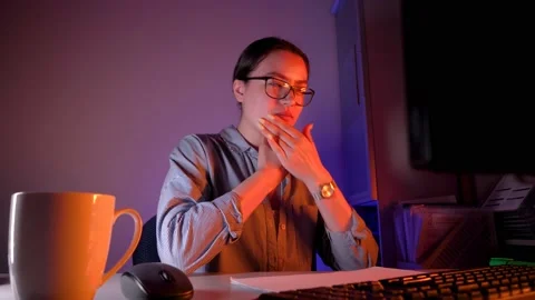 An office worker does exercises before the night shift. Exploitation of wome Stock Footage 154028857