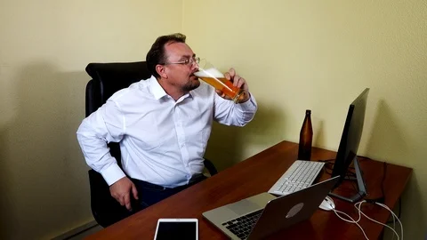 Office worker drinks beer after finishing work Stock Footage 115232851