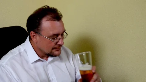 Office worker drinks beer after finishing work Stock Footage 115232908