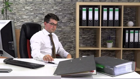 Office worker drinks coffee talking with a client at the workplace. Stock Footage 115877641