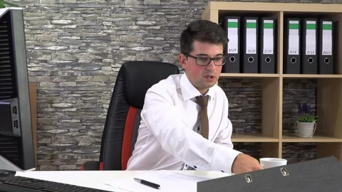 Office worker drinks coffee talking with a client at the workplace. Stock Footage 116704903