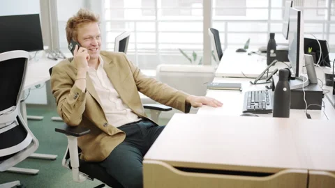 An office worker is engaged in a phone conversation within a modern work Stock Footage 281028467