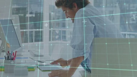 Office worker entering desk, sitting and tapping tablet, starting tech work as Stock Footage 334185367